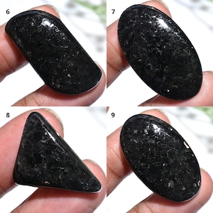 May include: A set of three ceramic mugs with a speckled, matte finish. The mugs are in shades of cream, light gray, and dark gray. Each mug has a simple, modern design and a rounded handle.