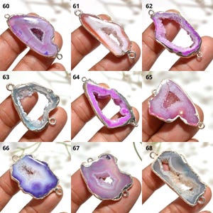 May include: Nine gemstone pendants with silver-coloured metal edging. The pendants display a range of colours, including pink, purple, orange, and blue, with a crystalline centre. Each pendant has two small loops for attaching to a chain or other jewellery component.