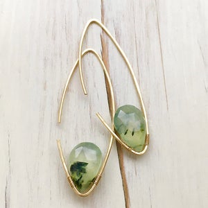 May include: Gold earrings with green and white gemstone drops. The earrings are made with a simple wire design.