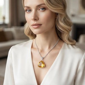 Large yellow sapphire trillion pendant 100-110 carats photographed in gift box, bright golden gemstone jewellery with prong setting and silver tone finish, bold statement necklace for women, luxury gifting idea for birthdays, anniversaries, and celebration outfits.
