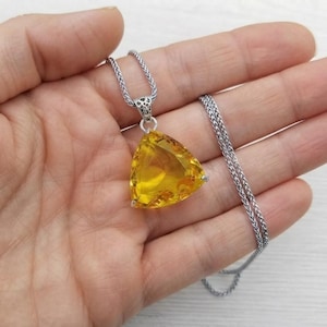 Yellow sapphire necklace with trillion cut pendant, 100-110 carat sunshine yellow gemstone in 3 prong setting, presented in gift box, bold statement jewellery for women with sleek snake chain style and bright golden color for special occasions and everyday glam wear.