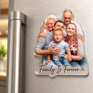 May include: A custom-shaped acrylic photo magnet featuring a multi-generational family portrait of five people. The image includes a blonde woman, a man, a younger couple, and a young child. The text "Family Is Forever" is printed in brown script.