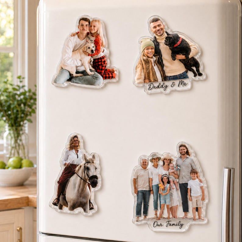 May include: Four custom acrylic photo magnets attached to a white refrigerator. The magnets feature various family portraits, including a couple with a dog, a person riding a horse, and a group photo with the text Daddy & Me and Our Family.