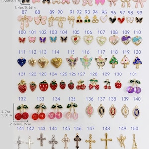 May include: A collection of metal charms numbered 76 through 150, featuring various shapes including bows, hearts, cherries, butterflies, strawberries, crosses, and religious icons. Some charms include enamel colors, pearls, or beads. Dimensions are shown.