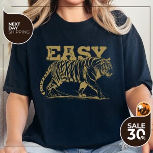 a woman wearing a t - shirt with a tiger on it