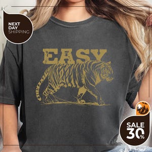 a woman wearing an easy tiger t - shirt