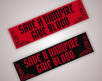 May include: Two rectangular stickers, one red and one black, with the phrase "SAVE A VAMPIRE GIVE BLOOD" in a gothic font. Each sticker has decorative corner flourishes in a contrasting color.