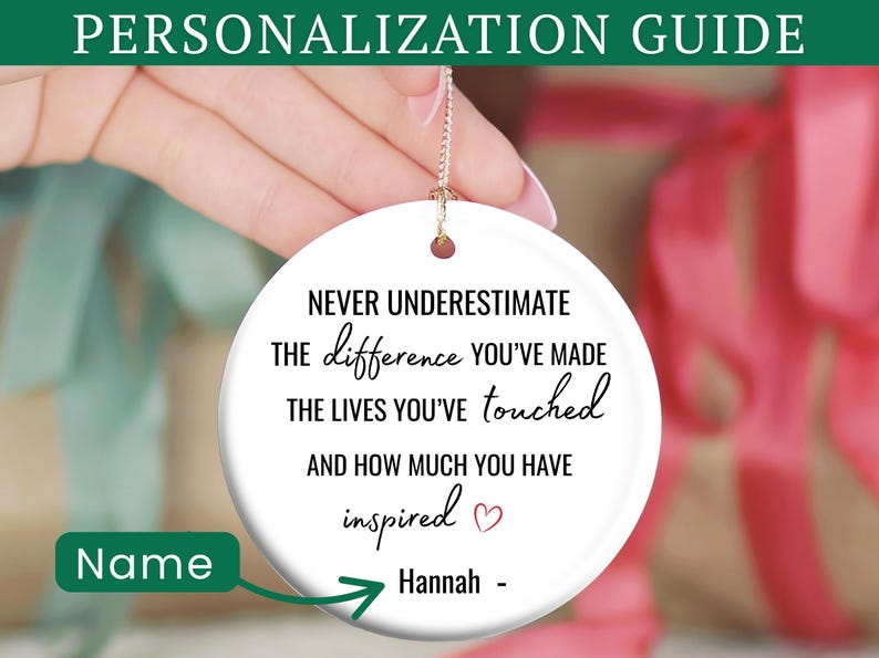 May include: A white ceramic ornament with a gold string, featuring the text "NEVER UNDERESTIMATE the difference you've made..." and a name. The ornament is held in front of a blurred background with gift boxes. The top banner reads "PERSONALIZATION GUIDE".