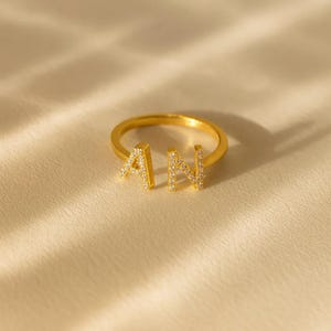 May include: A set of three ceramic mugs with a speckled, matte finish. The mugs are in shades of cream, light gray, and dark gray. Each mug has a simple, minimalist design, perfect for coffee or tea.