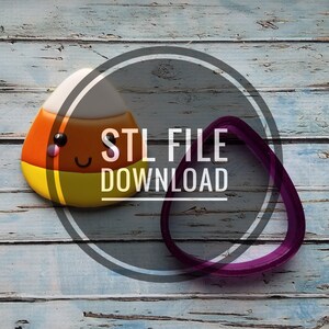 May include: A candy corn-shaped cookie with a smiling face, next to a purple teardrop-shaped cookie cutter. The image has the text "STL FILE DOWNLOAD" in a circular design. The background is a weathered, light blue wooden surface.