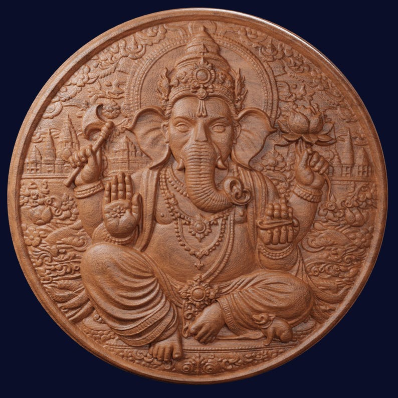 May include: A circular brown wooden wall plaque featuring a detailed relief carving of the deity Ganesha. The figure is depicted in a seated position with four arms, holding a lotus flower and an axe, surrounded by intricate temple architecture.