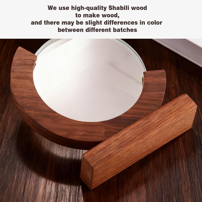 May include: A round, white mirror set in a dark brown, semi-circular wooden frame, with a matching rectangular wooden stand. The text in the image reads: "We use high-quality Shabili wood to make wood, and there may be slight differences in color between different batches."