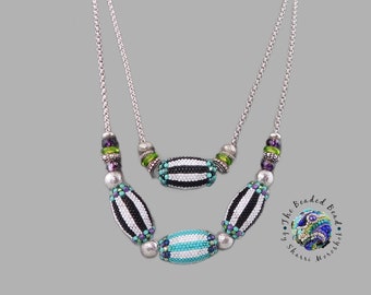 Layered chunky bead necklaces, bright striped beads on silver chains, black and white with playful color pops, by Sharri Moroshok