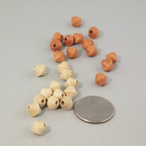 May include: A collection of wooden beads in two colors: light brown and a darker brown. The beads are shaped like a pyramid with a pointed top. There are 18 beads in total, with a US quarter coin for scale.