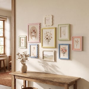 May include: A gallery wall arrangement featuring nine rectangular picture frames in pastel colors including pink, blue, yellow, green, and cream. The frames have scalloped or beaded edges and contain various illustrations of animals and flowers.