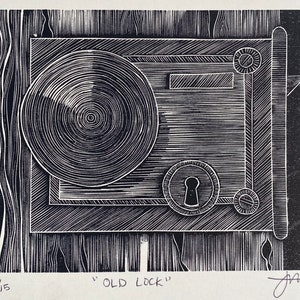 May include: A black and white woodcut print of an old lock. The lock is depicted in a stylized manner, with a circular keyhole and a rectangular handle. The print is titled "Old Lock" and is numbered 13/15.