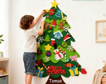 May include: A green felt Christmas tree with various ornaments, including a star, gingerbread man, and snowman. The text "Merry Christmas" and "Tomas" are visible. The image also includes the text "32PCS". A child is shown decorating the tree.