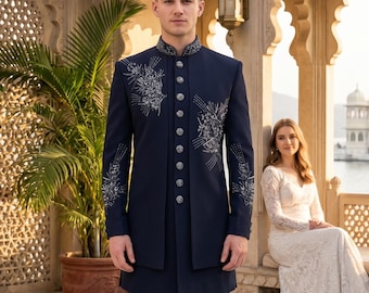 May include: A dark navy blue sherwani featuring a high mandarin collar, a front button placket with silver-toned buttons, and intricate silver floral embroidery on the chest and sleeves, paired with matching dark navy blue trousers.