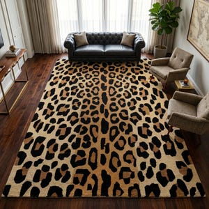 May include: A large rectangular area rug with a leopard print design. The rug features a tan background with black and brown spots. The rug is in a living room setting with a black leather sofa, two armchairs, and a potted plant.