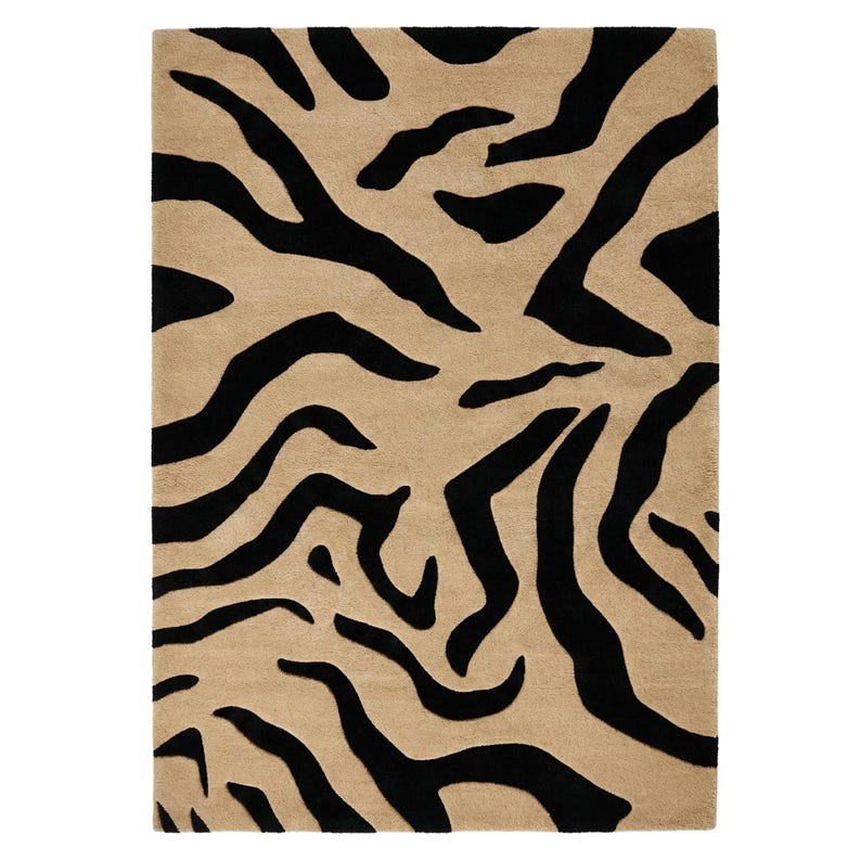 Pu&ograve; includere: Un tappeto rettangolare con sfondo beige e un audace motivo a strisce zebrate nere. Il design del tappeto presenta spesse strisce nere irregolari che creano un contrasto sorprendente sullo sfondo neutro. Un elemento di arredo per la casa.