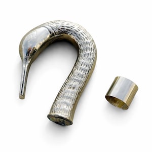 May include: A silver-toned, swan-shaped bottle stopper with a textured body and a separate silver-toned ring. The swan's head and beak are smooth and polished. The stopper is designed to fit into a bottle.