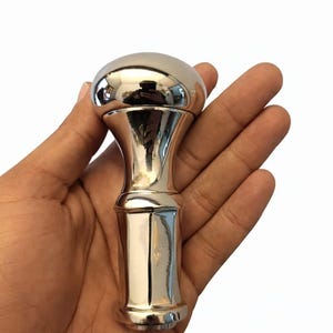 May include: A set of three ceramic mugs with a speckled, matte finish. The mugs are in shades of cream, light gray, and dark gray. Each mug has a simple, minimalist design and a rounded handle.