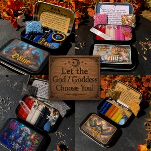 May include: A collection of four metal pocket altar tins featuring deities like Odin and Venus, each containing small ritual candles, crystals, and printed invocations, centered around a wooden sign reading Let the God / Goddess Choose You!