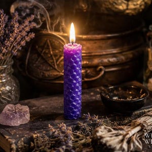 May include: A cylindrical purple candle with a textured honeycomb pattern and a lit flame. The candle stands upright, emitting a thin trail of smoke from the wick. The wax surface features a repeating hexagonal design across its entire length.