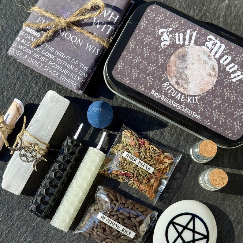 May include: A Full Moon Ritual Kit with various components. Includes a tin with "Full Moon Ritual Kit" text, candles, herbs, offering rice, and a stone with a pentagram. The kit is tied with twine and has a scroll and a blue sphere.