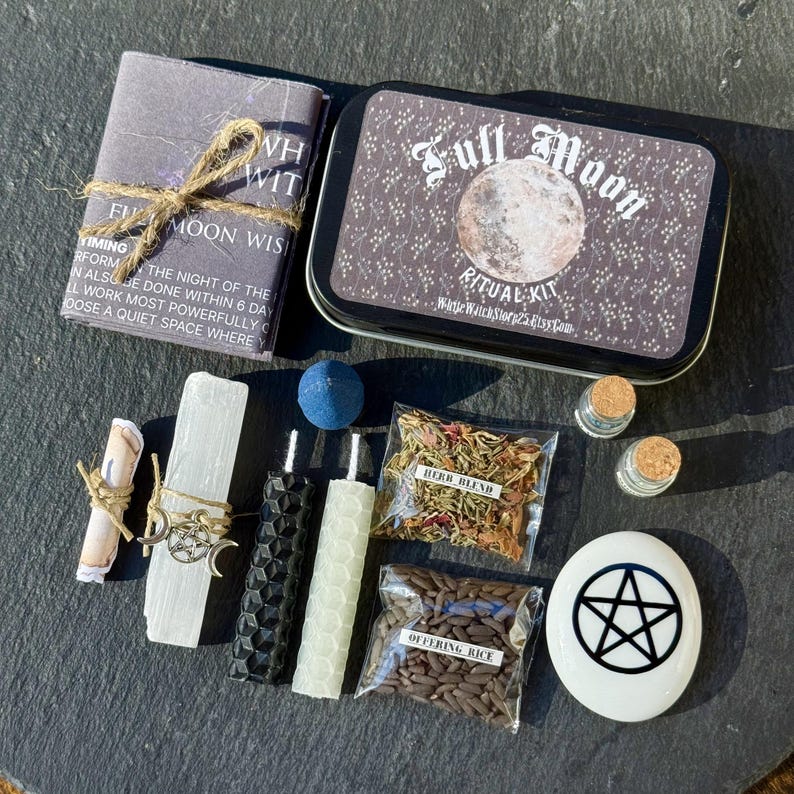 May include: A Full Moon Ritual Kit with various components. Includes a tin with a moon graphic, a small book, candles, herbs, rice, a blue sphere, and a pentacle stone. The kit is designed for spiritual practices.