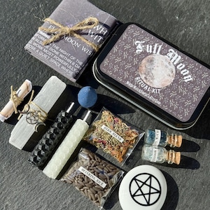 May include: A Full Moon Ritual Kit with various components. Includes a metal tin with a moon graphic, candles, herbs, rice, and small bottles. Also includes a small book with text about timing and performing rituals.