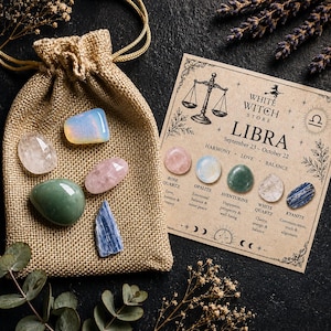 May include: A tan burlap drawstring pouch and a rectangular card labeled White Witch Store Libra. The card features a scale illustration and lists five polished stones: rose quartz, opalite, aventurine, white quartz, and blue kyanite.