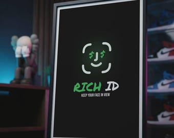 May include: Framed art print with a black background featuring a green and white graphic of a face with dollar signs for eyes. The text "RICH ID" and "KEEP YOUR FACE IN VIEW" are below the graphic. The frame is black.