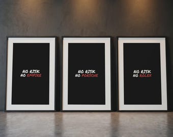 May include: Three framed prints with black frames and white matting. Each print has a black background with white and red text that reads "NO RISK" above a word: "EMPIRE", "PORSCHE", and "ROLEX". The prints are displayed on a gray surface.