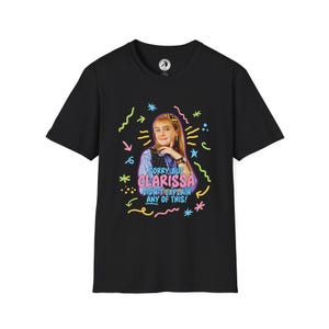 May include: Black t-shirt featuring a graphic of a woman with the text "Sorry, But Clarissa Didn't Explain Any of This!" in a colorful design. The design includes stars, squiggles, and arrows.