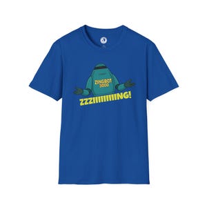 May include: A royal blue t-shirt featuring a cartoon robot with the text "ZINGBOT 3000" and "ZZZIIIIIIING!". The robot is green and black with its arms out. The shirt is a short-sleeved crew neck.