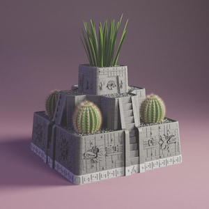 May include: A gray, tiered planter shaped like an ancient temple, featuring detailed carvings and steps. It holds three cacti and tall green grass. The planter is a unique decorative item for indoor or outdoor use.