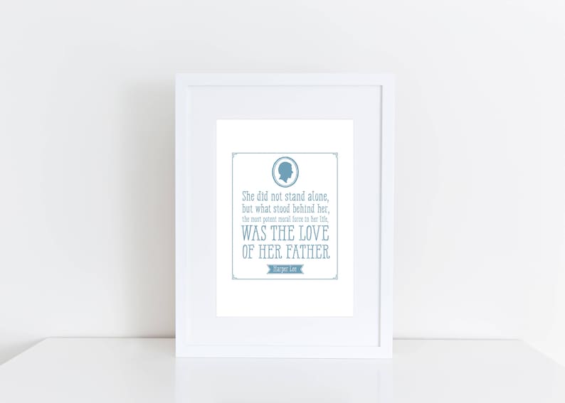 May include: A white framed print with a blue silhouette of a person's head and a quote that reads "She did not stand alone, but what stood behind her, the most potent moral force in her life, WAS THE LOVE OF HER FATHER."