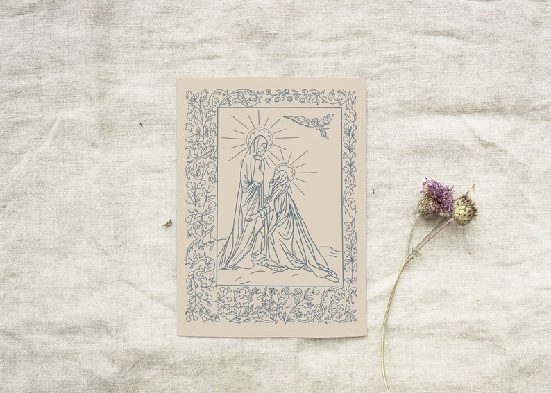 May include: A beige art print featuring a blue line drawing of two figures with halos, framed by floral and leaf motifs. A dove flies above. Dried flowers are in the lower right corner.