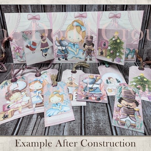 May include: A set of nine Christmas-themed gift tags featuring illustrations of a nutcracker, a ballerina, a mouse, a Christmas tree, and a snow globe. The tags are printed on a pink background with white accents and have a rustic, vintage aesthetic.
