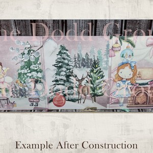 May include: A three-panel Christmas card featuring a winter scene with a ballerina, a mouse playing a trumpet, a deer, and a girl in a blue dress. The card has a pink background and a wooden frame.
