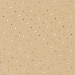 May include: A tan fabric featuring a repeating pattern of small, evenly spaced polka dots in alternating colors of white and muted olive green. The textile has a visible woven texture and a consistent, flat layout across the entire surface.
