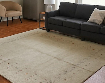 Handgeknoopt ivoorwollen vloerkleed: minimalistisch tribal design