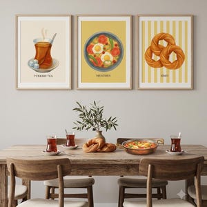 May include: Three framed wall art prints featuring illustrations of Turkish food and drink. The left print shows Turkish tea with sugar cubes, the center print depicts a bowl of menemen, and the right print displays simit on a yellow striped background.