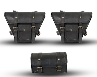 May include: Three black leather motorcycle saddlebags with brass-colored buckles and straps. Two are triangular, and one is cylindrical. Each bag has a front pocket and is designed for motorcycle use.