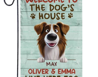 May include: A garden flag with the text "WELCOME TO THE DOG'S HOUSE" in red and brown. A cartoon dog with brown and white fur is featured. The names "MAX" and "OLIVER & EMMA LIVE HERE TOO" are also displayed.