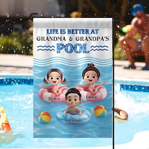 May include: A personalized garden flag with the text "LIFE IS BETTER AT GRANDMA & GRANDPA'S POOL." The flag features cartoon illustrations of three children in inner tubes and beach balls. The children's names are Sophia, Emma, and Henry.