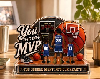 May include: A basketball-themed acrylic display with the words "You are our MVP" and "You Dunked Right Into Our Hearts." It features a basketball, hoop, and figures wearing blue jerseys. Includes a scoreboard and two basketballs.