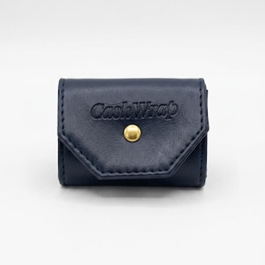 May include: A navy blue leather CashWrap wallet with a gold-colored snap closure. The wallet is rectangular with a flap closure and stitched edges. The embossed text "CashWrap" is visible on the front.