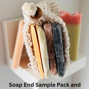 May include: A collection of colorful soap samples in a sisal cotton bag, displayed on a white shelf. The soaps vary in color, including peach, yellow, white, pink, and black. The text "Soap End Sample Pack and Sisal Cotton Bag" is at the bottom.